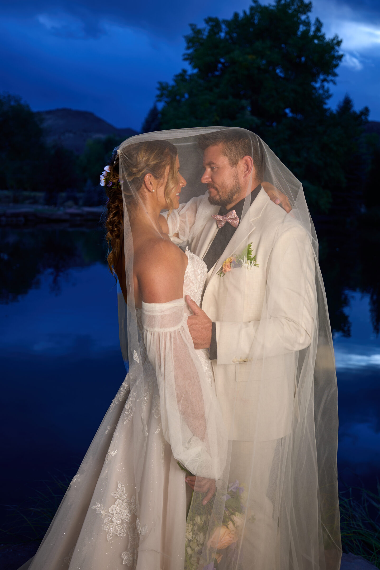 Intimate under-veil portrait of bride and groom at blue hour, Lazy Stud Ranch Lyons Colorado